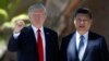 President Donald Trump and Chinese President Xi Jinping pause for photographs at Mar-a-Lago, Friday, April 7, 2017, in Palm Beach, Fla. Trump was meeting again with his Chinese counterpart Friday, with U.S. missile strikes on Syria adding weight to his threat to act unilaterally against the nuclear weapons program of China's ally, North Korea.