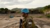FILE - A UN soldier patrols the area surrounding the village of Kafe, at Lake Albert in Ituri, March 27, 2018. Conflict between members of the Lendu and Hema tribes has caused the instability within the Ituri region and thousands of Hema people to flee.