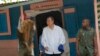 U.N. Secretary-General Ban Ki-moon walks out after visiting the house of a cholera victim during the launching of sanitation campaign in Hinche, Haiti, July 14, 2014. 