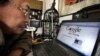Award winning Chinese blogger Lao Hu Miao, or Zhang Shihe, a critic of China's internet censorship, looks at a webpage with the Chinese words "Google considers leaving the Chinese market" in Beijing, March 23, 2010. 