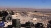 Cannon aims at rebel positions in strategic rebel-held Yabroud area, near Damascus, Feb. 15, 2014.