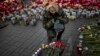 A Ukrainian woman wearing camouflage uniform pays respect at the site were her friend Ustim Golodniuk was killed in clashes with the police at the Shrine of the Fallen in Kiev&#39;s Independence Square, Ukraine, March 5, 2014. 