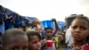 FILE - A girl balances a bowl of food on her head at an Internally Displaced People's (IDP) camp in Faladie, where hundreds have found refuge after fleeing inter-communal violence in central Mali, May 14, 2019.