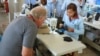 Factory owner Piet Holten checking the handiwork of one of his employees. (S. Herman/VOA)
