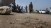 Pakistani police officers and local residents gather at the site of firing incident at Garhi Sohbat Khan on the outskirts of Peshawar, Sept. 18, 2016. Two gunmen on a motorcycle killed three soldiers Sunday, police said.
