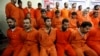 FILE - Handcuffed al-Qaida-linked suspects sit in the terrorist combat and organized crime department in Baghdad, Iraq, Dec. 2, 2010.